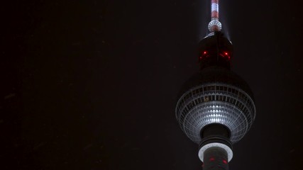 Berliner Fernsehturm Television Tower at night in winter with snow falling, Alexanderplatz, Mitte District, Berlin, Germany, Europe