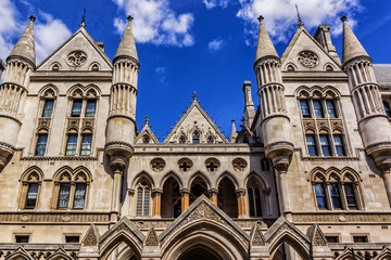 Fototapeta na wymiar Architectural fragments of Royal Courts of Justice Complex. Royal Courts of Justice in the Victorian Gothic style (or Law Courts, was opened in December 1882) in London, UK.