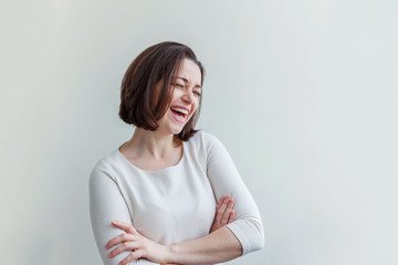 Happy girl smiling. Beauty portrait young happy positive laughing brunette woman on white background isolated. European woman. Positive human emotion facial expression body language