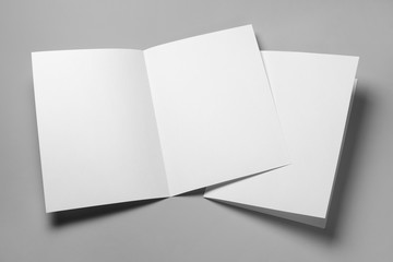 Blank half-folded booklet, postcard, flyer or brochure mockup template on gray background