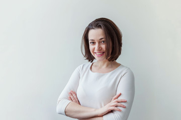 Obraz premium Happy girl smiling. Beauty portrait young happy positive laughing brunette woman on white background isolated. European woman. Positive human emotion facial expression body language