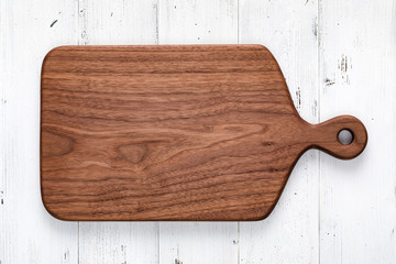 Handmade walnut chopping board on white wooden board top
