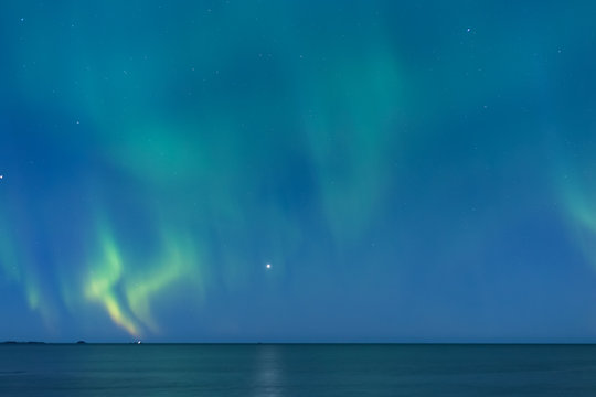 Beautiful northern lights over the snow covered winter landscape of the Lofoten islands