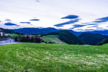 Alpe di Siusi, Seiser Alm with Sassolungo Langkofel Dolomite, a large green field with a mountain in the background