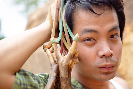 Thai Man In Yellow Plaid Shirt In Nature Environment