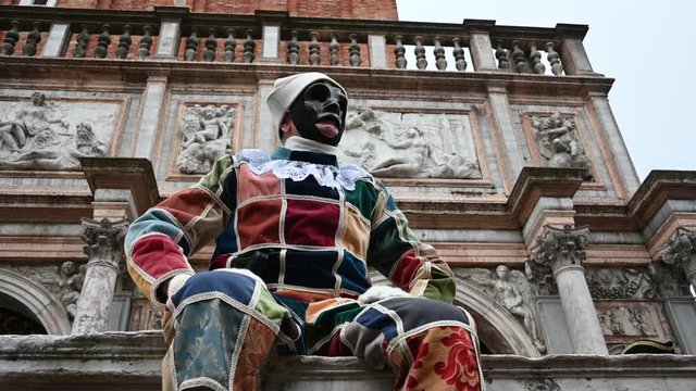 Venice - carnival masks are photographed with tourists in Piazza San Marco