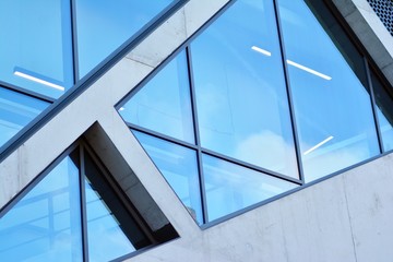 Abstract image of looking up at modern glass and concrete building. Architectural exterior detail of office building. 