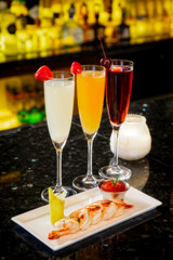 specialty drinks and shrimp cocktail appetizer on bar