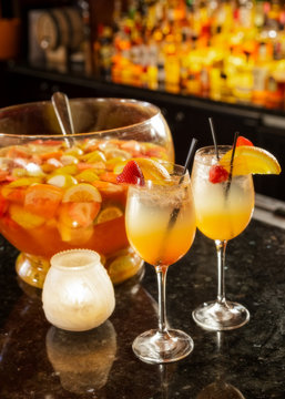 Specialty punch in punch bowl and drinks on bar
