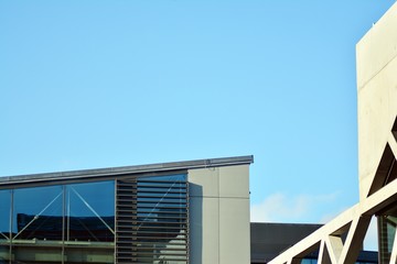 Abstract image of looking up at modern glass and concrete building. Architectural exterior detail of office building. 