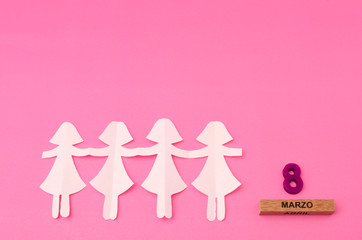 Paper doll chain and march eight made from wooden rectangle an purple number on pink background