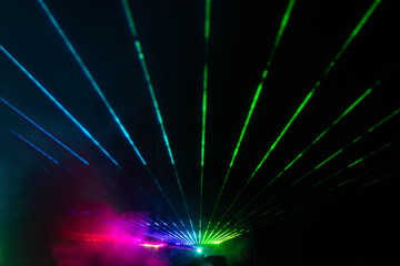 Night concert lights at the festival with lasers