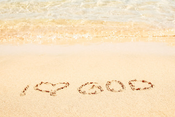 Beautiful drawing on the sand of the sea background