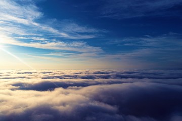 Fototapeta na wymiar Sun above clouds with a blue sky. Fantastic landscape. Peace, Freedom, overcoming, inspirational, God. Great sky view! Drone flying above clouds. Sunrise view. 