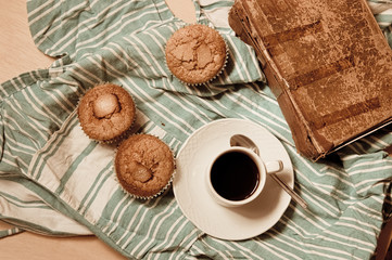 Flat lay of a snack with muffins, coffee and a good book