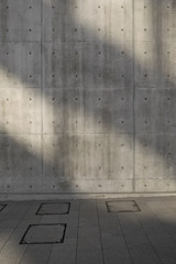 The window shadows on the concrete wall