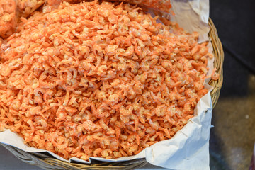 Top view heap of dried shrimps on basket are sold in Thai local seafood  market.