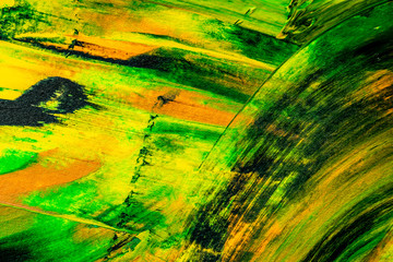 Paint texture abstract background. Colorful macro close up paint brush strokes green, yellow, orange, black. 