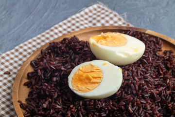 riceberry rice and boiled eggs on wooden plate