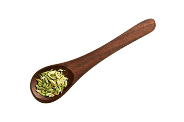 fennel seeds in wooden spoon isolated on white background, saunf