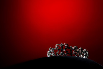 Silver Diamond Crown of Miss Pageant Beauty Universe World Contest sparkle light on black pillow, ready for wear Most beautiful Winner, studio lighting super red gradient background dramatic