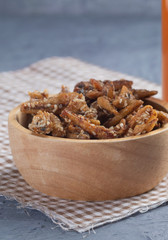 fried crispy small fish on wooden bowl