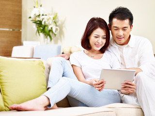 Fototapeta premium asian couple using digital tablet together