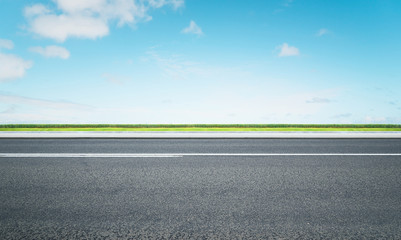 Road with green and beautiful blue sky  , morning scene .