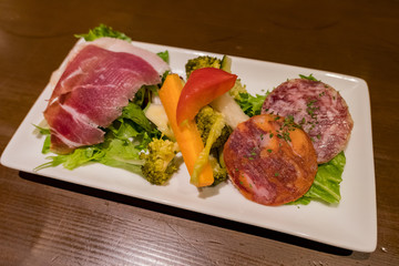 Close up shot of a salad made of sausage and ham slice with vegetable