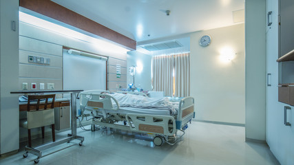 hospital recovery patient single room with fully furnished with a female patient with saline unit on bed - Powered by Adobe