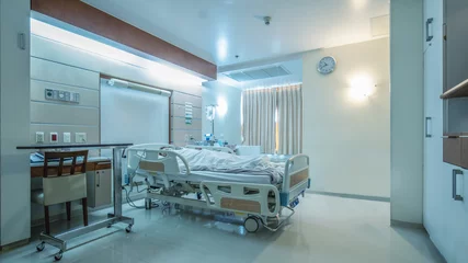 Fotobehang hospital recovery patient single room with fully furnished with a female patient with saline unit on bed © Mongkolchon