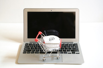 Online shopping concept : trolley cart on a laptop keyboard