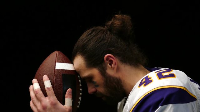 Close up portrait of American Football Player with ball