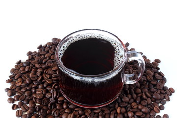 dark roasted coffee beans with coffee cup closeup on white background top view 