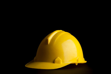 Yellow safety Engineer and Architect  helmet on black background.