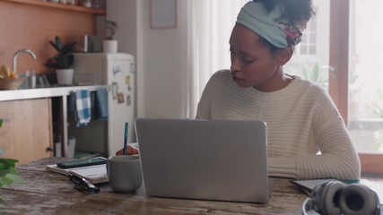 young woman using laptop computer working from home student brainstorming project researching information online writing notes enjoying study