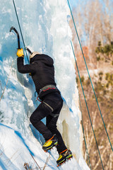 Woman ice climbing