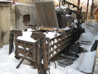 Old rusty press for compressing municipal solid waste