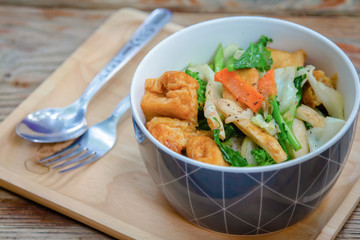 White cabbage, kale, baby corn, mushrooms and fried tofu, and oyster sauce in a bowl of breakfast,mixed vegetable stir-fried healthy menu