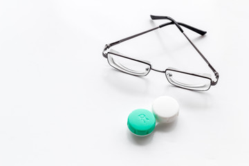 Eye problems. Glasses with transparent lenses and contact lenses on white background space for text