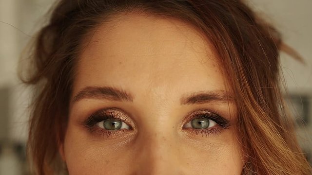 Beautiful woman's green eyes as she smiles - Front View