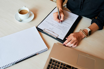 Businesswoman filling contract