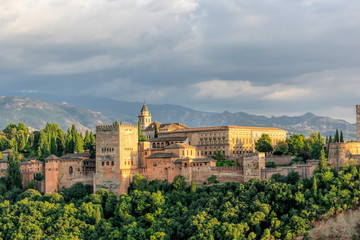 Fototapeta na wymiar Aerial view of Alhambra Palace in Granada, Andalusia, Spain from Mirador of San Nicolas in Albayzin neighborhood with Sierra Nevada mountains at the background