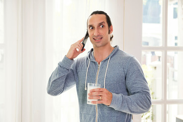 Man cringing face when calling on phone