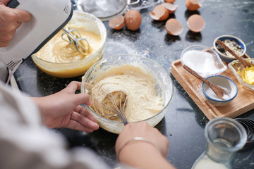 Woman making liquid dough