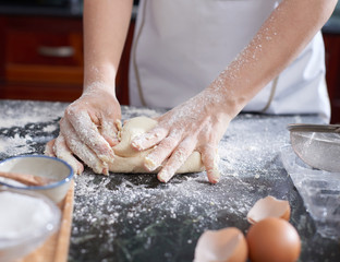 Hands kneading dough