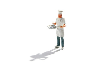 Master chef in toque and apron with a pan