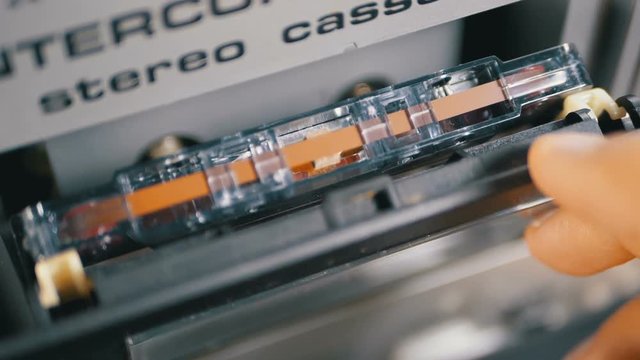 Audio Cassette is inserted into the Deck of the Audio Tape Recorder in Slow motion