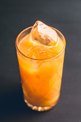 Fresh beverage with mandarines on the rustic background. Selective focus. Shallow depth of field. 