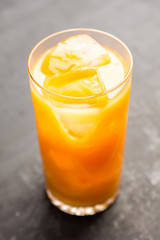Fresh beverage with mandarines on the rustic background. Selective focus. Shallow depth of field. 